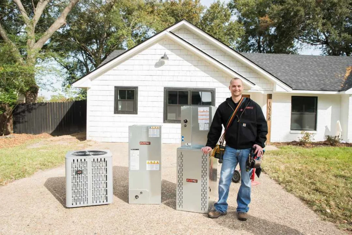 Reid Pro technician installing a Trane furnace and air conditioner
